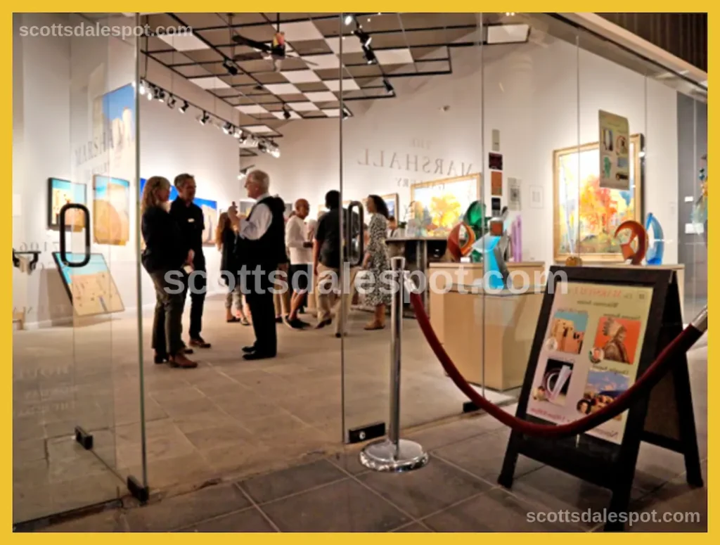 Historic Main Street in Old Town Scottsdale lined with Southwest art galleries adobe buildings and visitors browsing outdoor sculptures