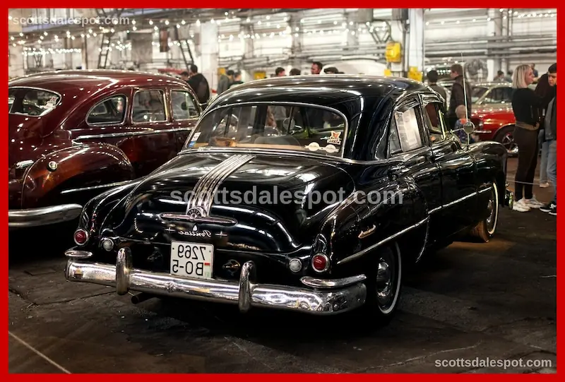 Classic cars in staging lanes with engines running before collector car auction