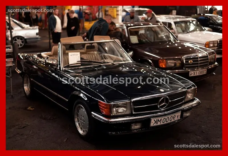 Crowd watching collector car auction with bidders and spectators
