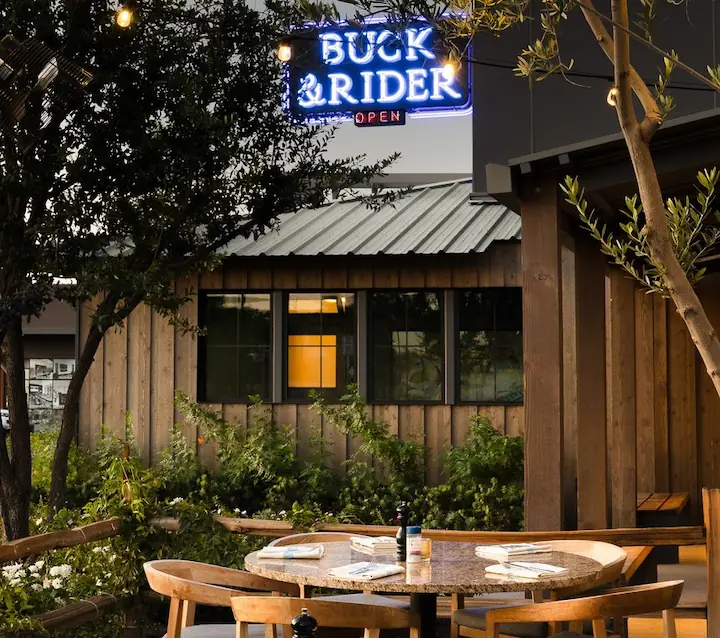 Buck and Rider Scottsdale outdoor patio neon sign string lights evening dining