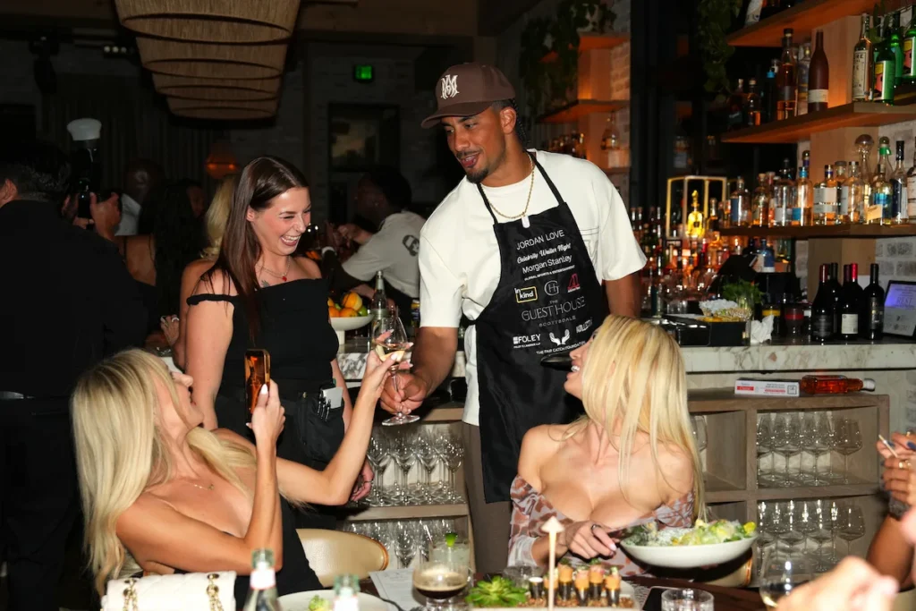 NFL players serving dinner tableside at Celebrity Waiter Night charity event in Scottsdale