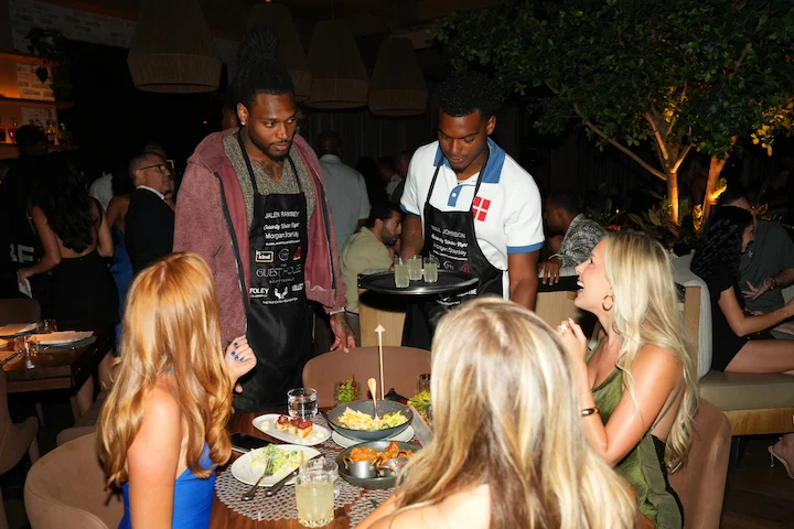 NFL quarterback serving wine to guests at Celebrity Waiter Night 2026 at The Guest House Scottsdale